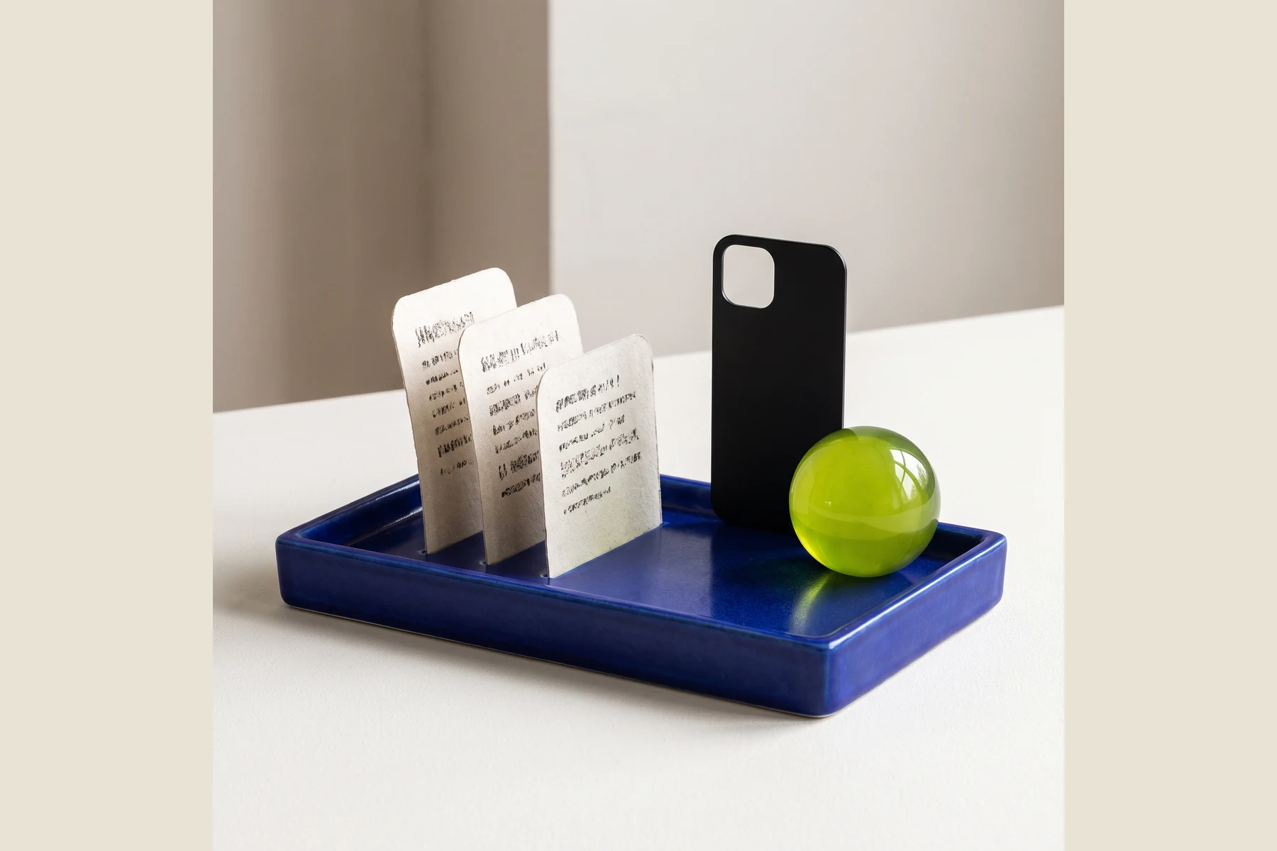 Printed paper slips beside a phone on a blue tray